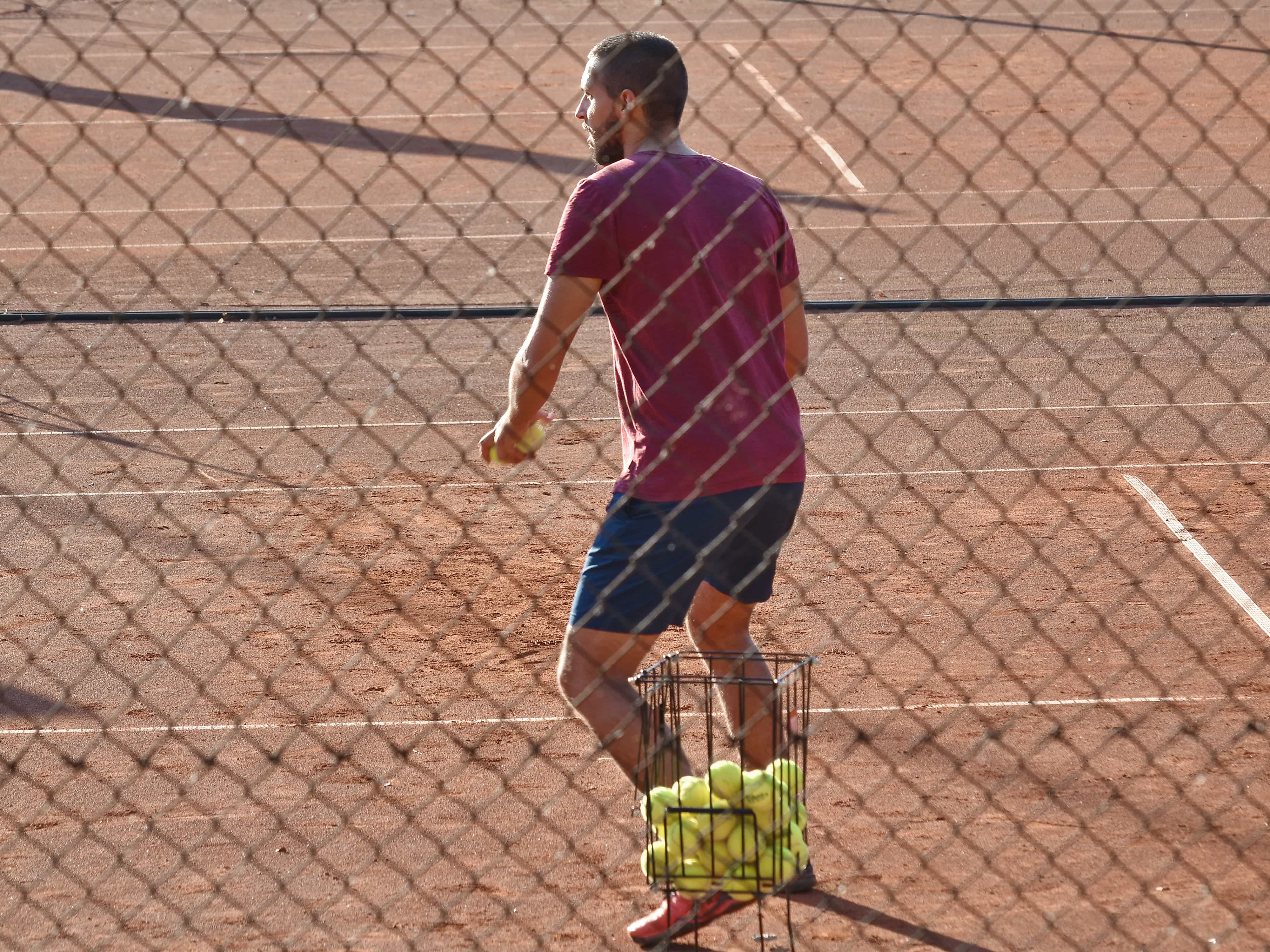 Experienced tennis coach on court with player Brazil style