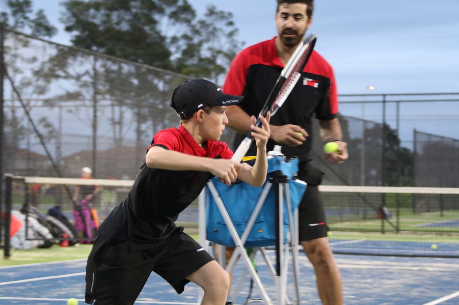 Tennis coach motivating junior player