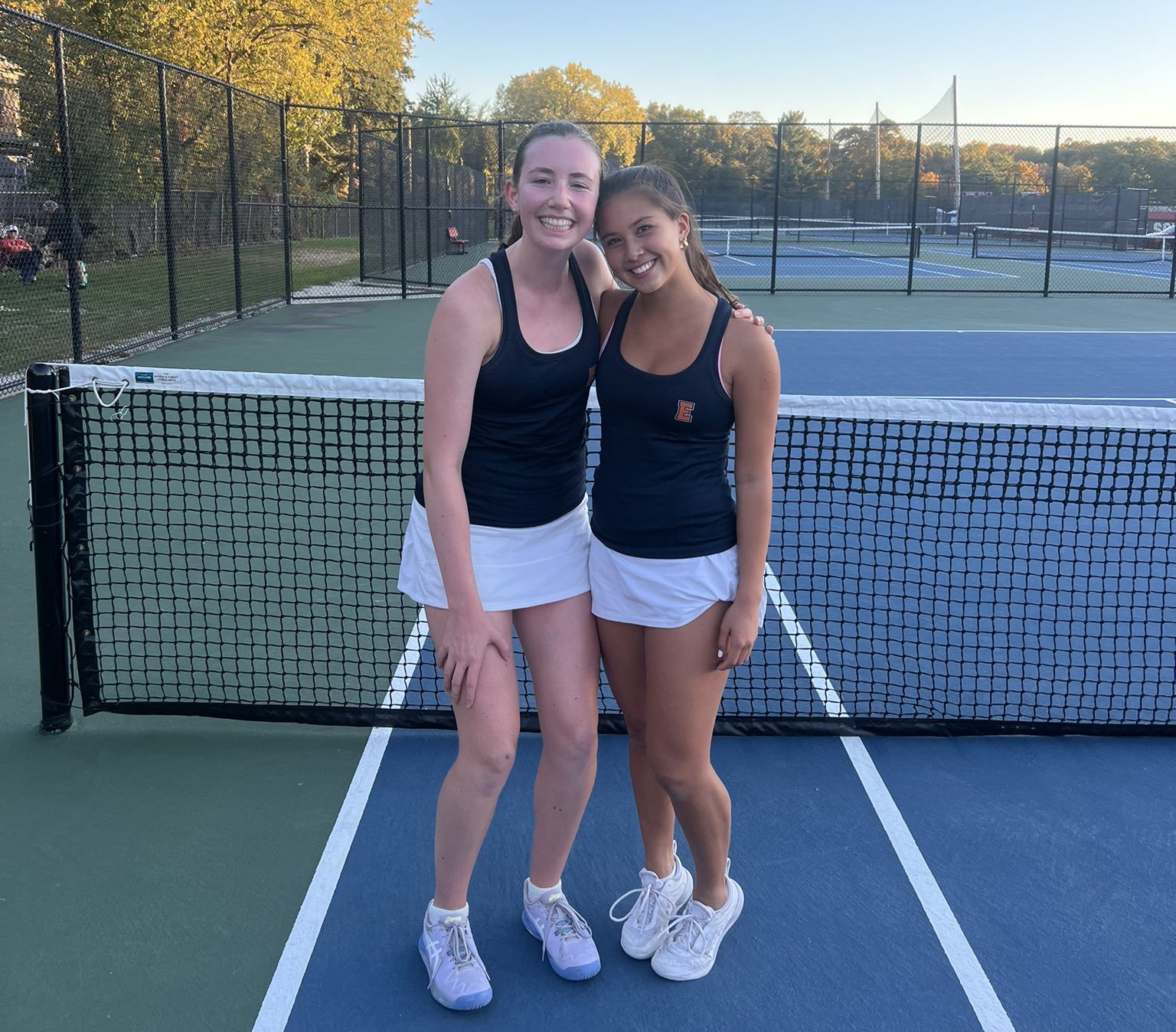 High school girls tennis doubles team in action